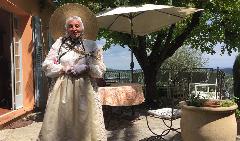 Madame Isnard in traditional Provence costume conducting tour of the gardens